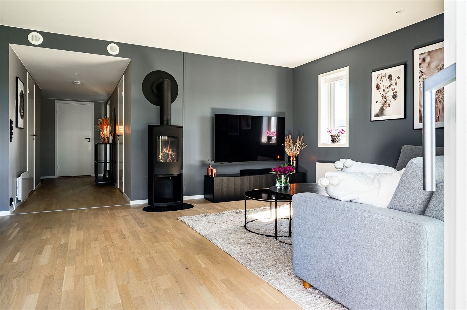 Som et fint midtpunkt i stuen er det en moderne vedovn som både gir god varme og bidrar til ekstra hygge. Galleribilde