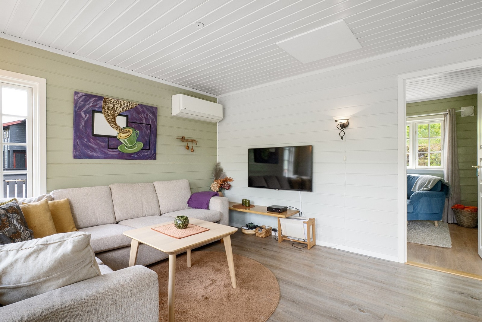 Lys stue med god plass til sofagruppe og tilhørende møblement. Galleribilde