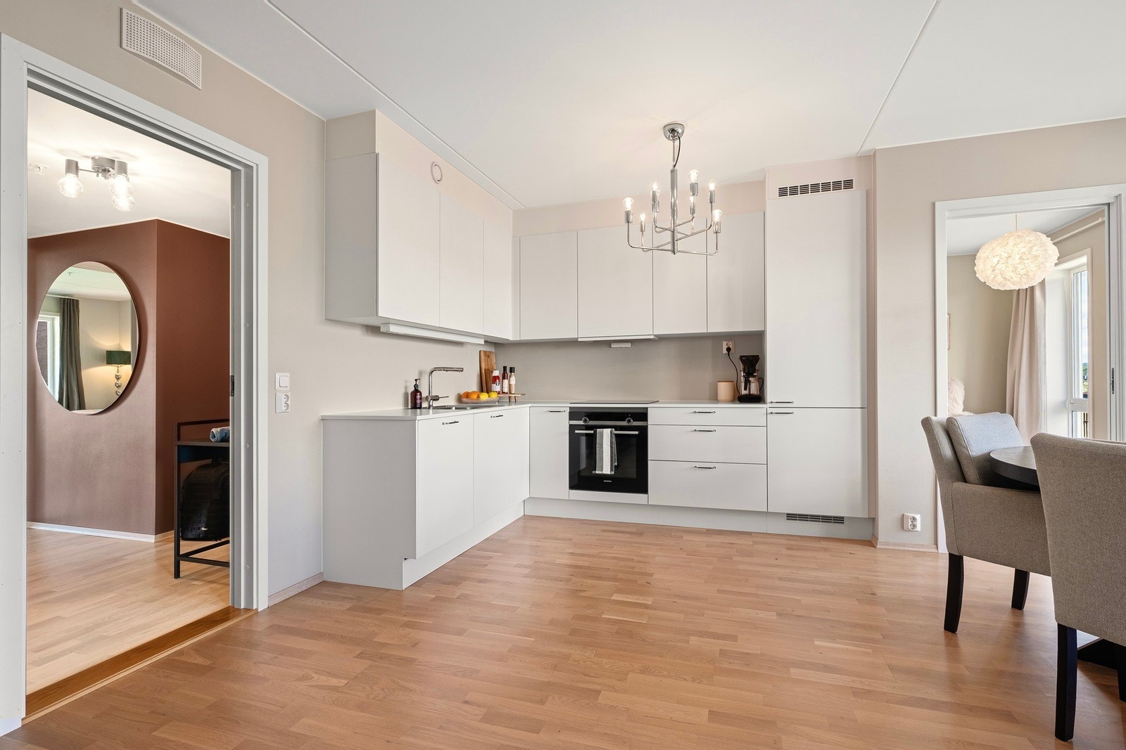 Kjøkkenet har en moderne innredning med glatte fronter og en benkeplate av slitesterkt laminat. Galleribilde