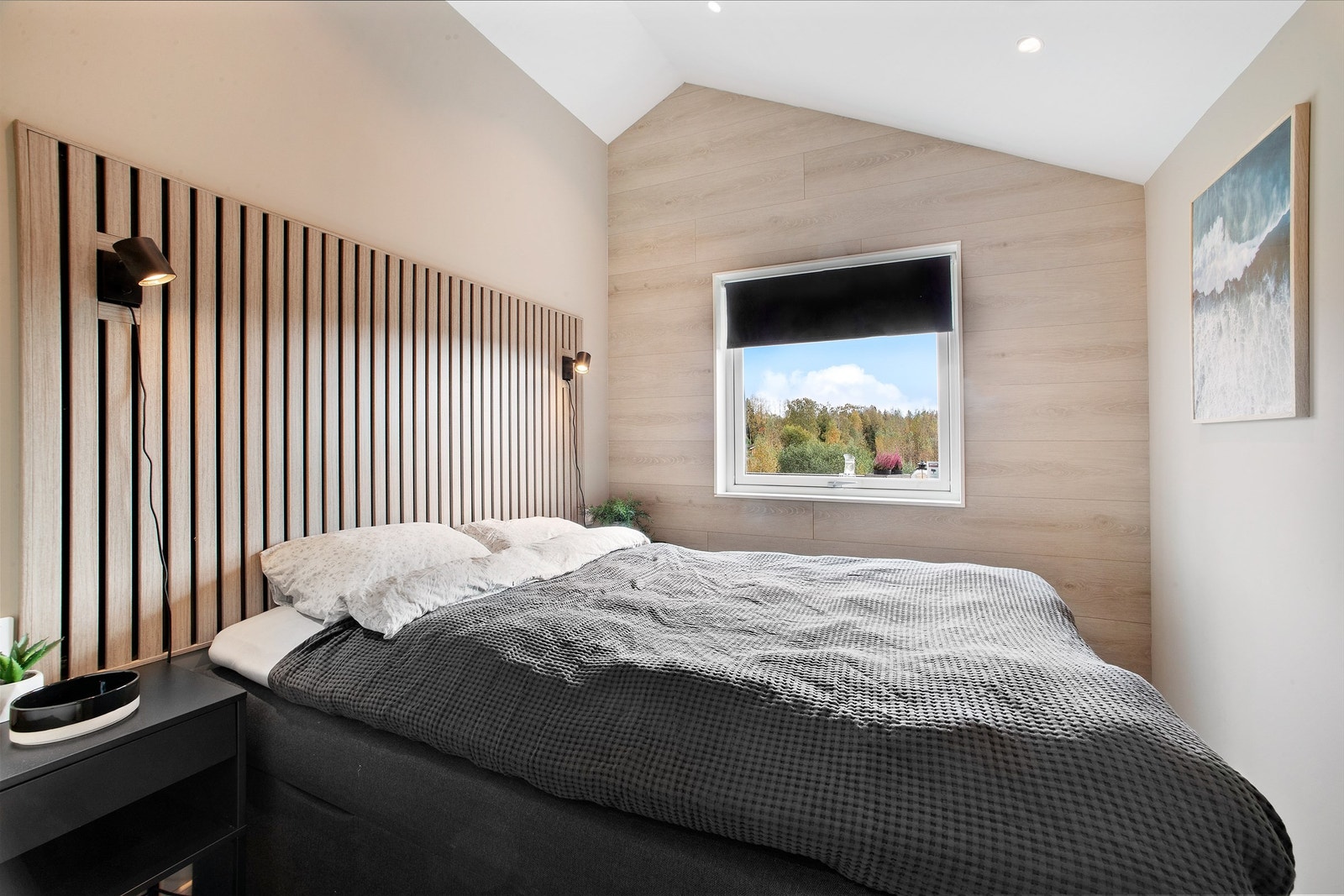 Soverom med plass til dobbeltseng og nattbord. Moderne spiler på vegg. Galleribilde