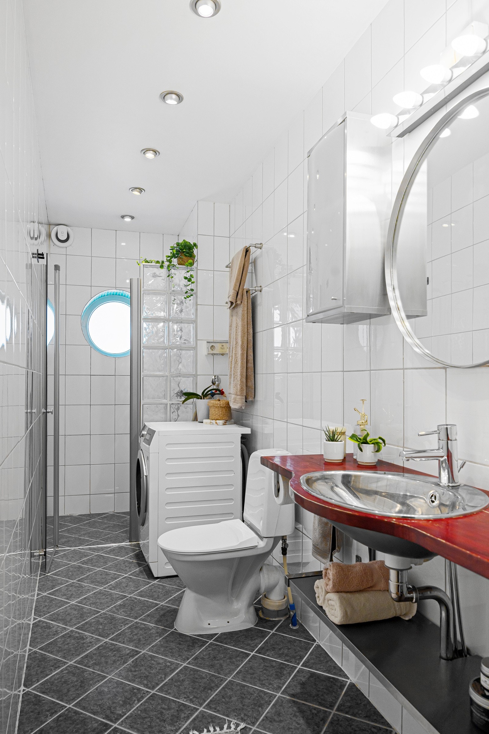 - Dusjnisje med vegg i glassbyggerstein og svingbar glassdør, toalett, vegghengt servant med hylle, 2 stk vegghengte skap og speil med lys - Galleribilde