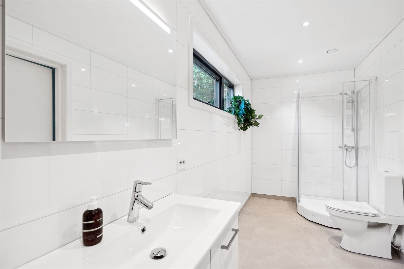 Bad i utleiedelen med flis på gulv og varmekabler Galleribilde