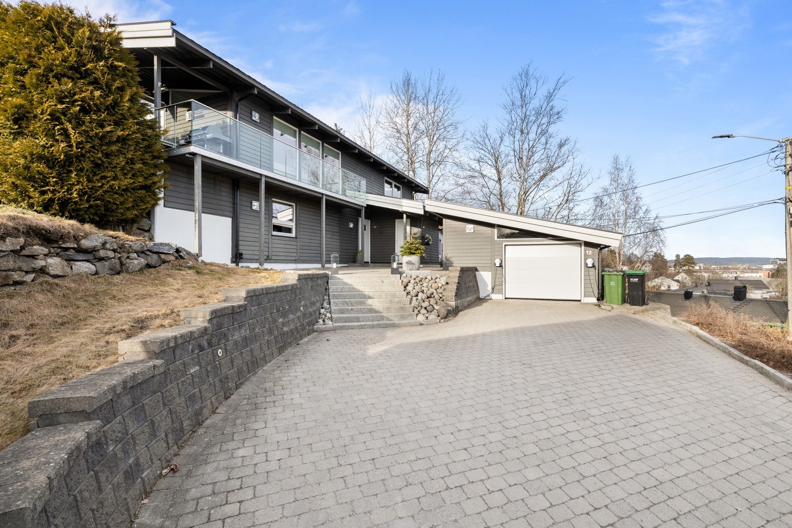 Gårdsplassen er steinbelagt med god plass til kjøretøyene og frittliggende garasje. Galleribilde