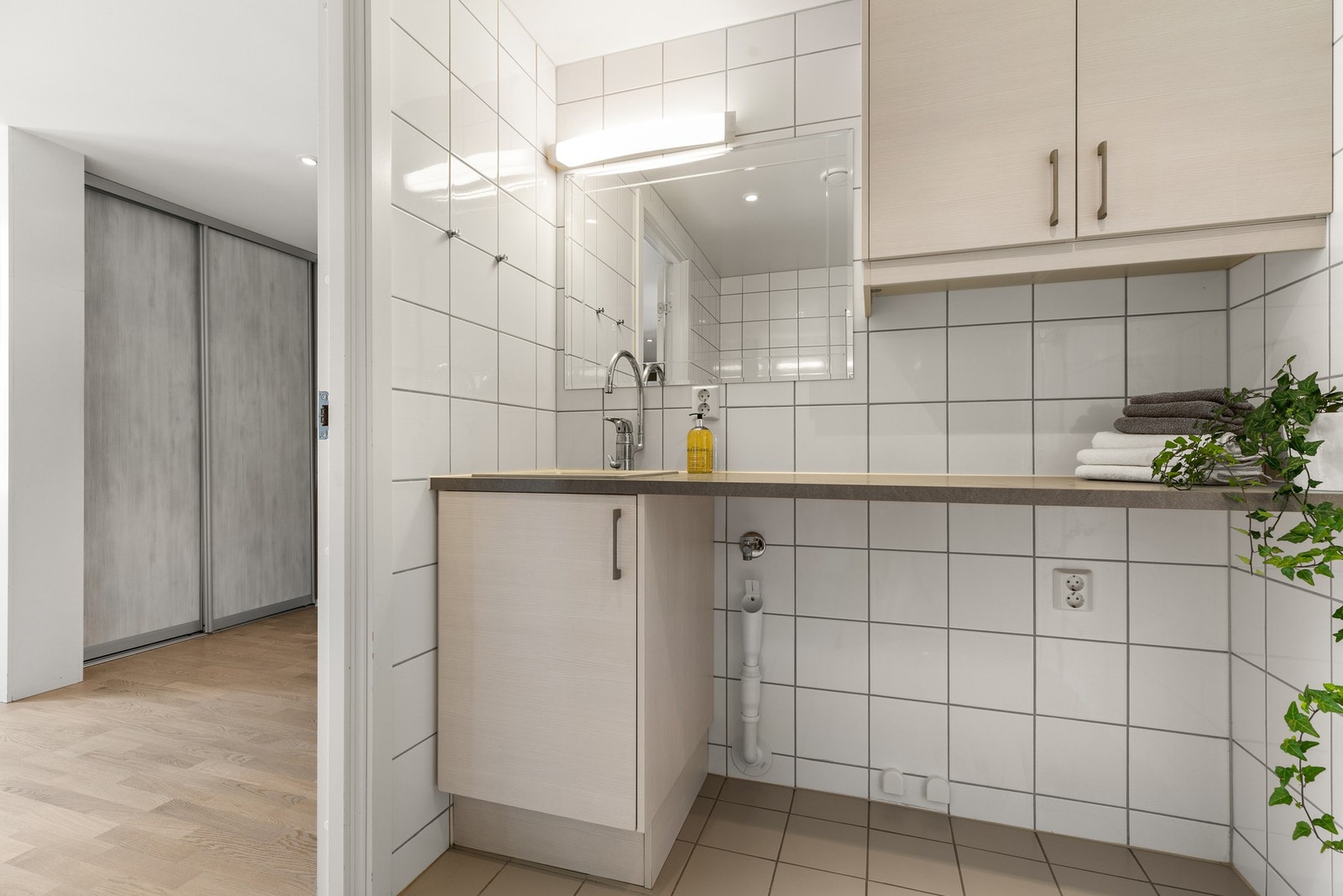 Det flislagte badet/vaskerom ved entré har også opplegg for vaskemaskin under benkeplate. El varmekabler i gulv Galleribilde