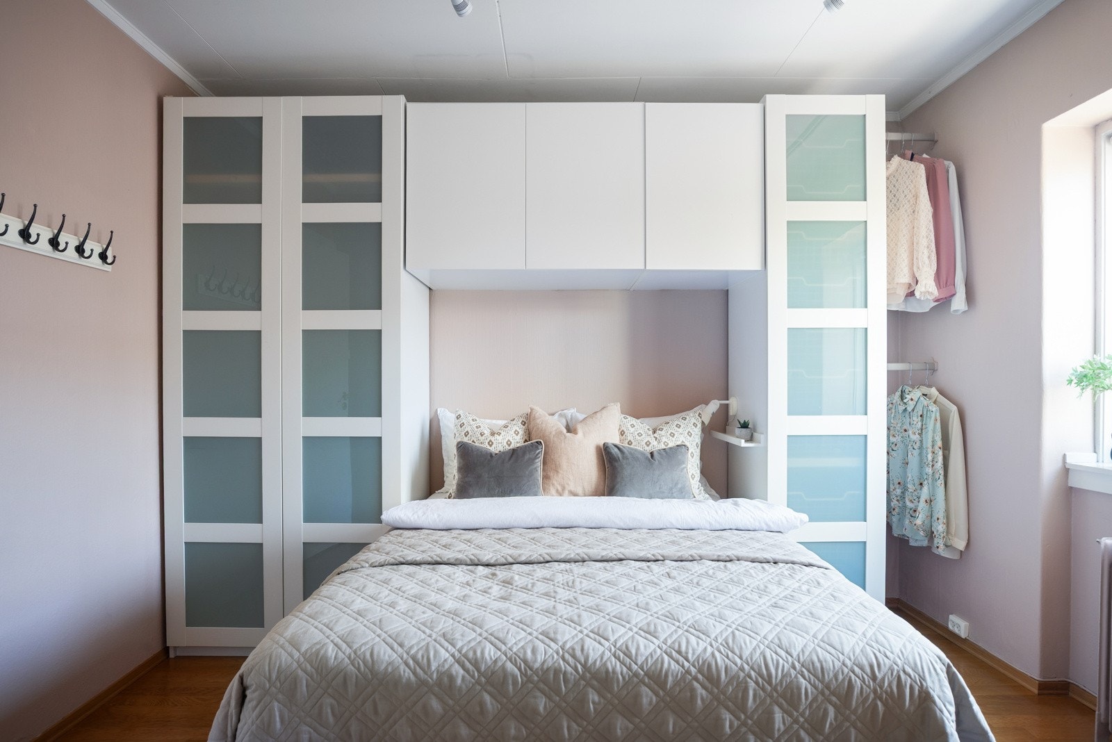 Klær kan ryddes pent vekk i en garderobe som rammer inn sengen Galleribilde
