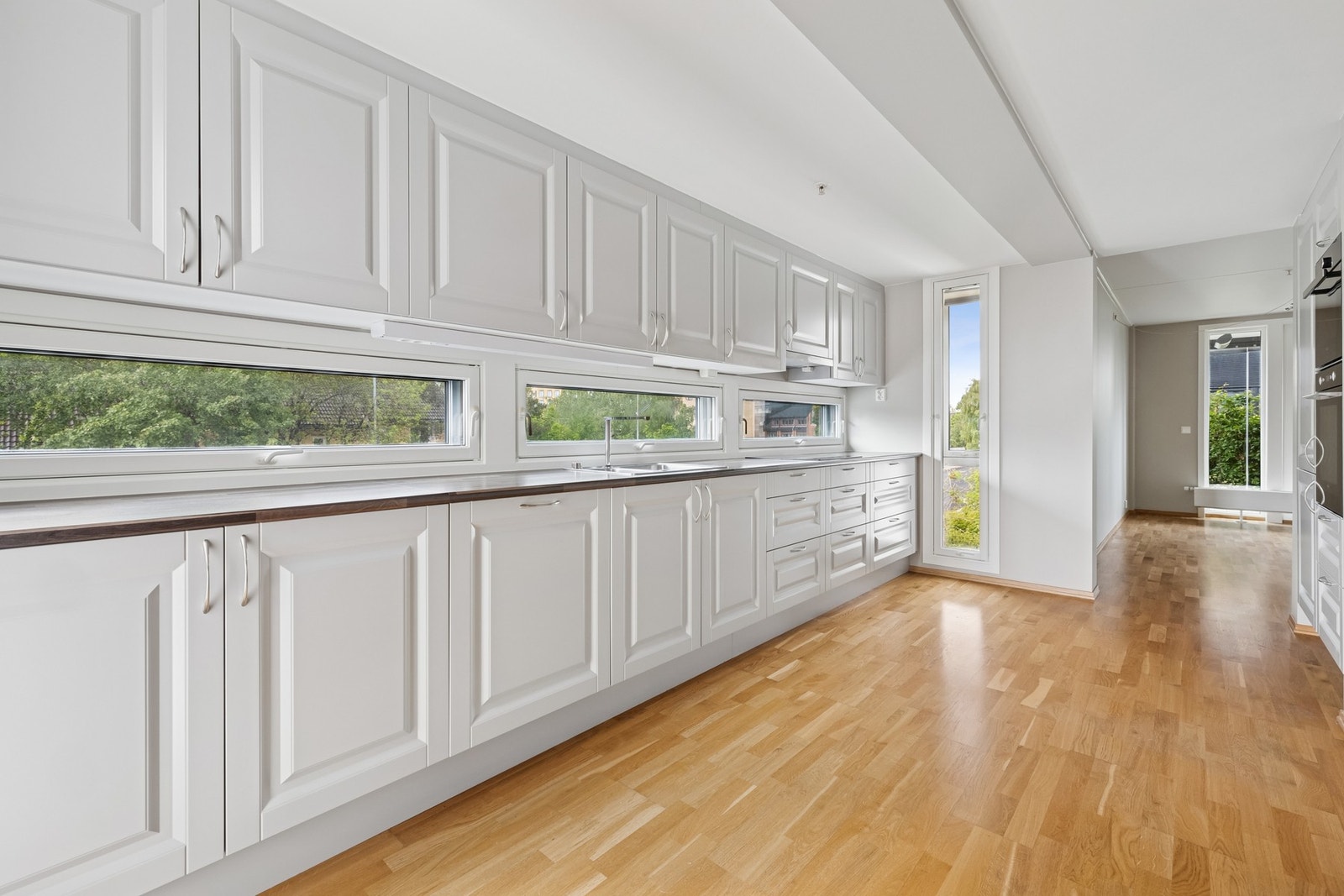 Kjøkkenet er unikt med vinduer imellom kjøkkenbenk og overskap langs hele benken, noe som slipper inn lys på en helt unik måte. Galleribilde