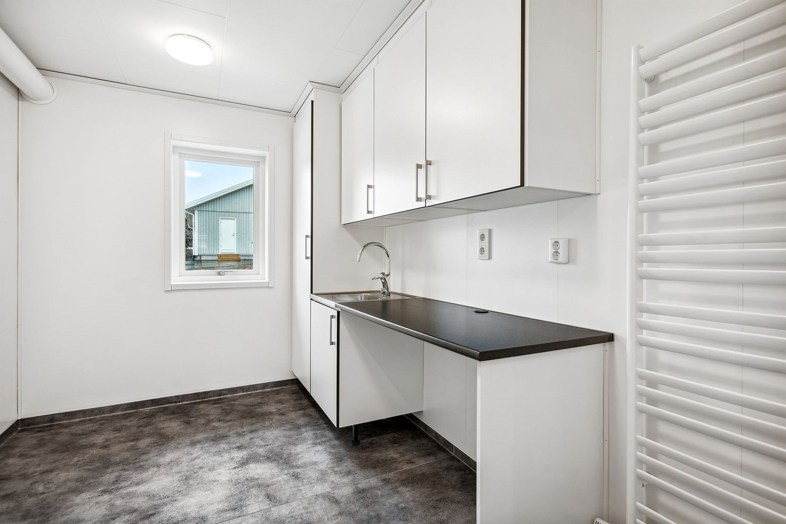 Separat vaskerom med innredning, nedfelt oppvaskkum i benk. Galleribilde