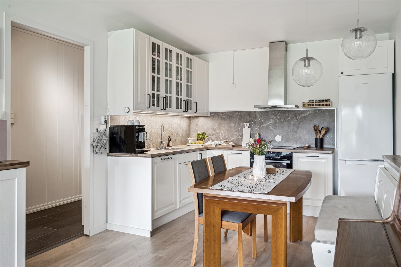 Et lekkert hvitt kjøkken. God skap -og benkeplass. Galleribilde