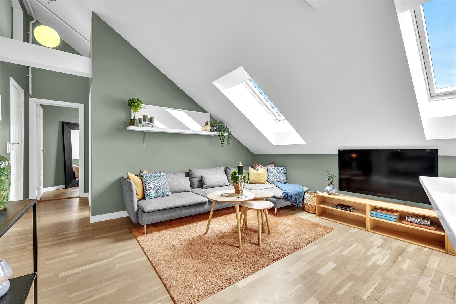 Leiligheten har en takhøyde optil 3,8 meter og godt med lysinslipp fra de store takvinduene Galleribilde