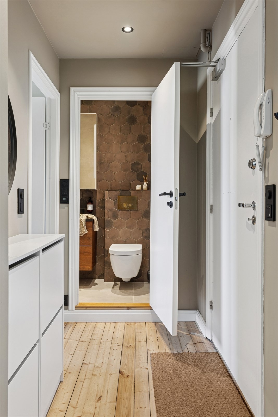 Tiltalende entré med lysmalte overflater, originale tregulv og downlights i himlingen, som gir et godt førsteinntrykk av boligen. Galleribilde