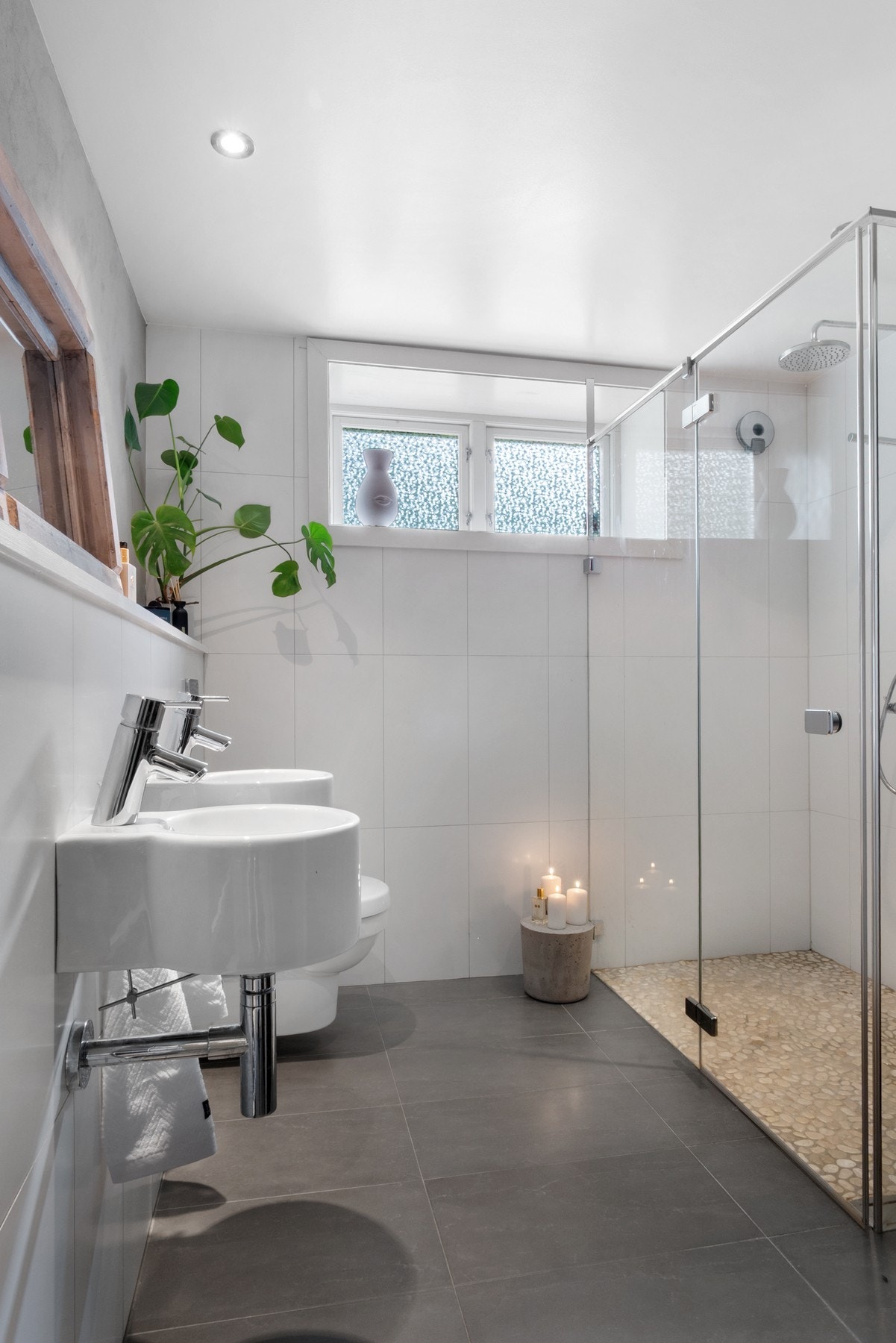 Badet er utstyrt med to servanter, romslig dusjhjørne og veggmontert wc Galleribilde