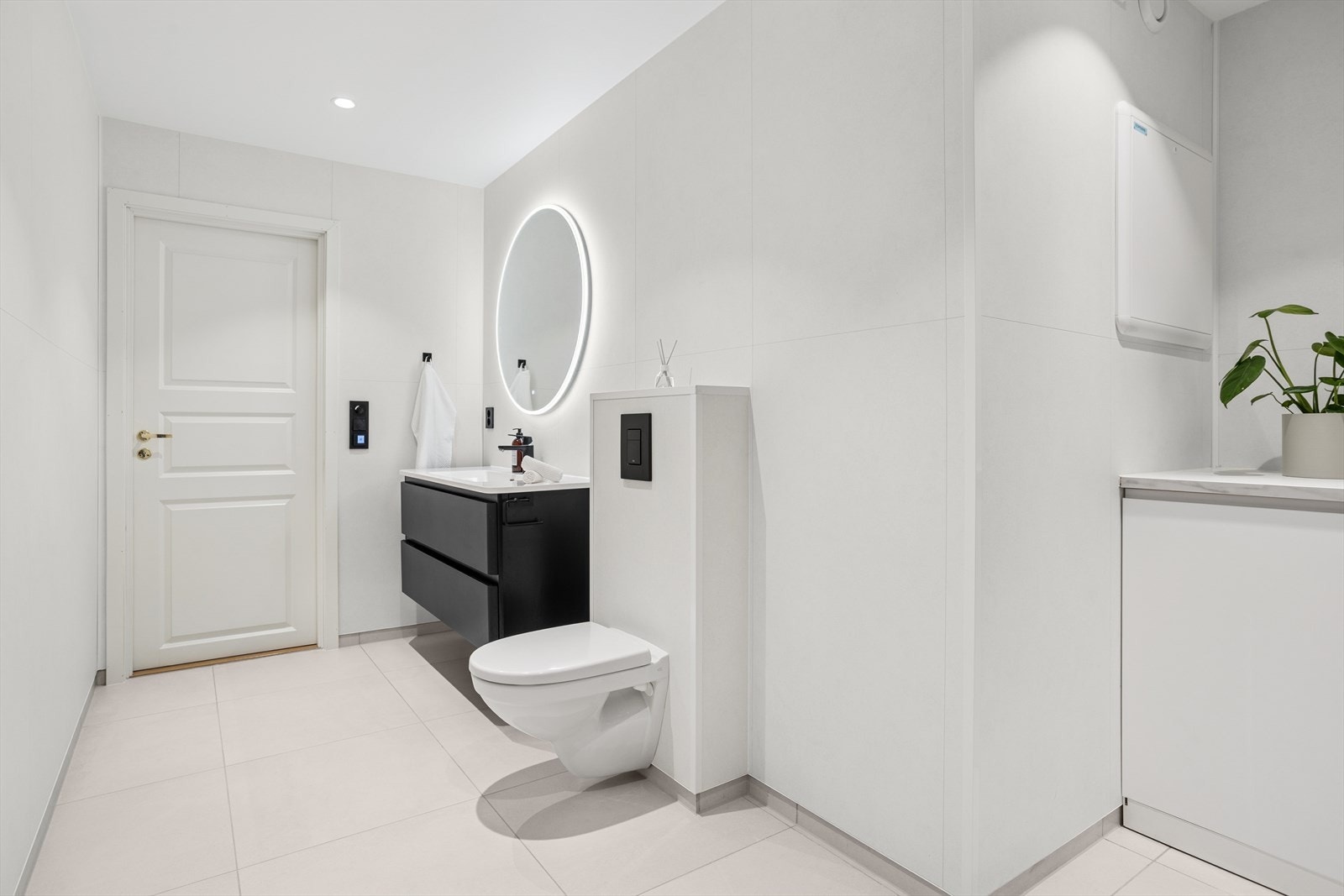 Bad 2: stilfult og lyst baderom med fliser på gulv over nedstøpte, elektriske varmekabler. Galleribilde