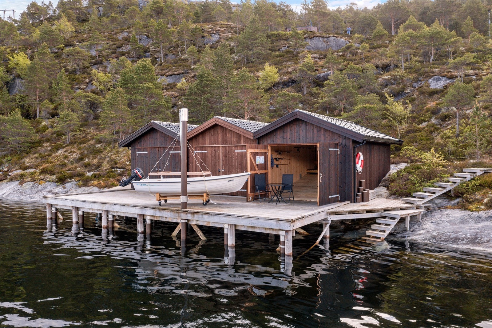 Eiendommen inkluderer innholdsrik hytte, uthus og naust med felles brygge. Galleribilde