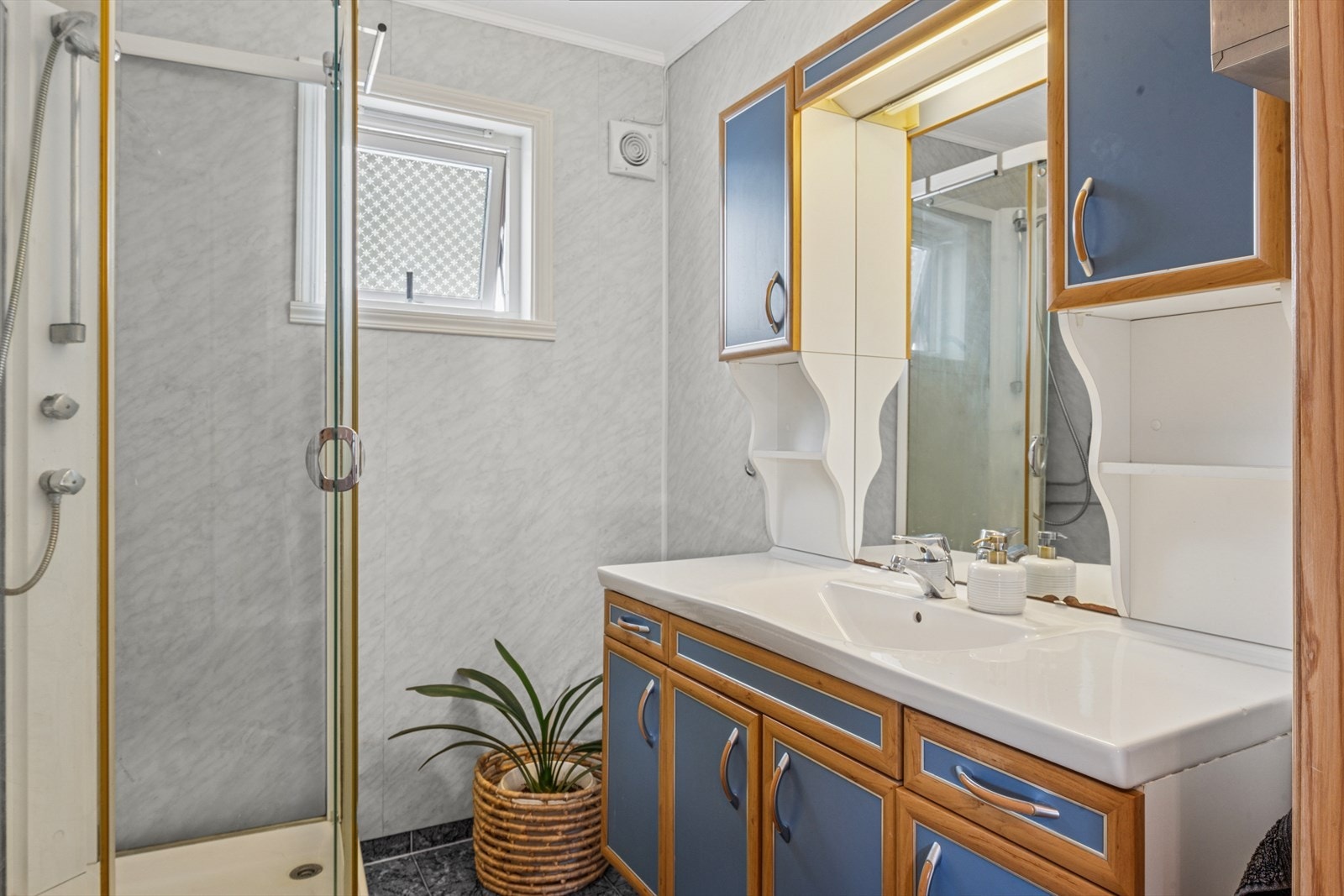 Romslig baderomsinnredning med mye oppbevaringsplass for baderomsartikler. Galleribilde