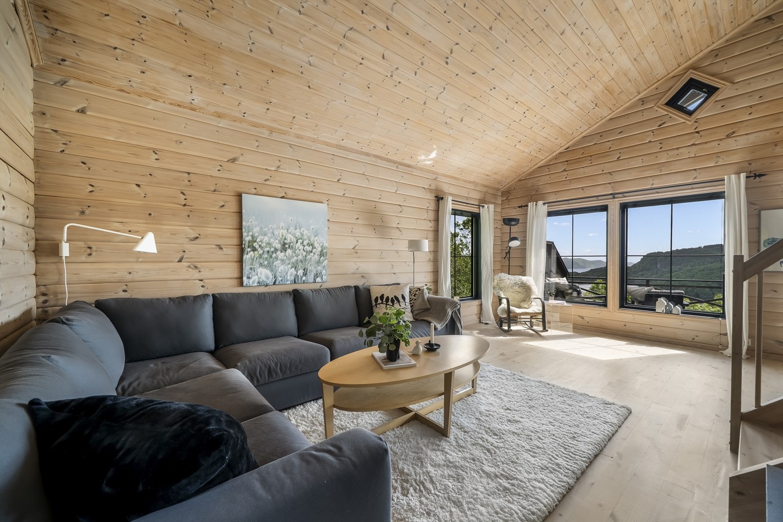 Lys, lun og innbydende stue med store vinduer og fantastisk utsikt over naturskjønne omgivelser. Perfekt plass for avslapning og hygge, lun Galleribilde