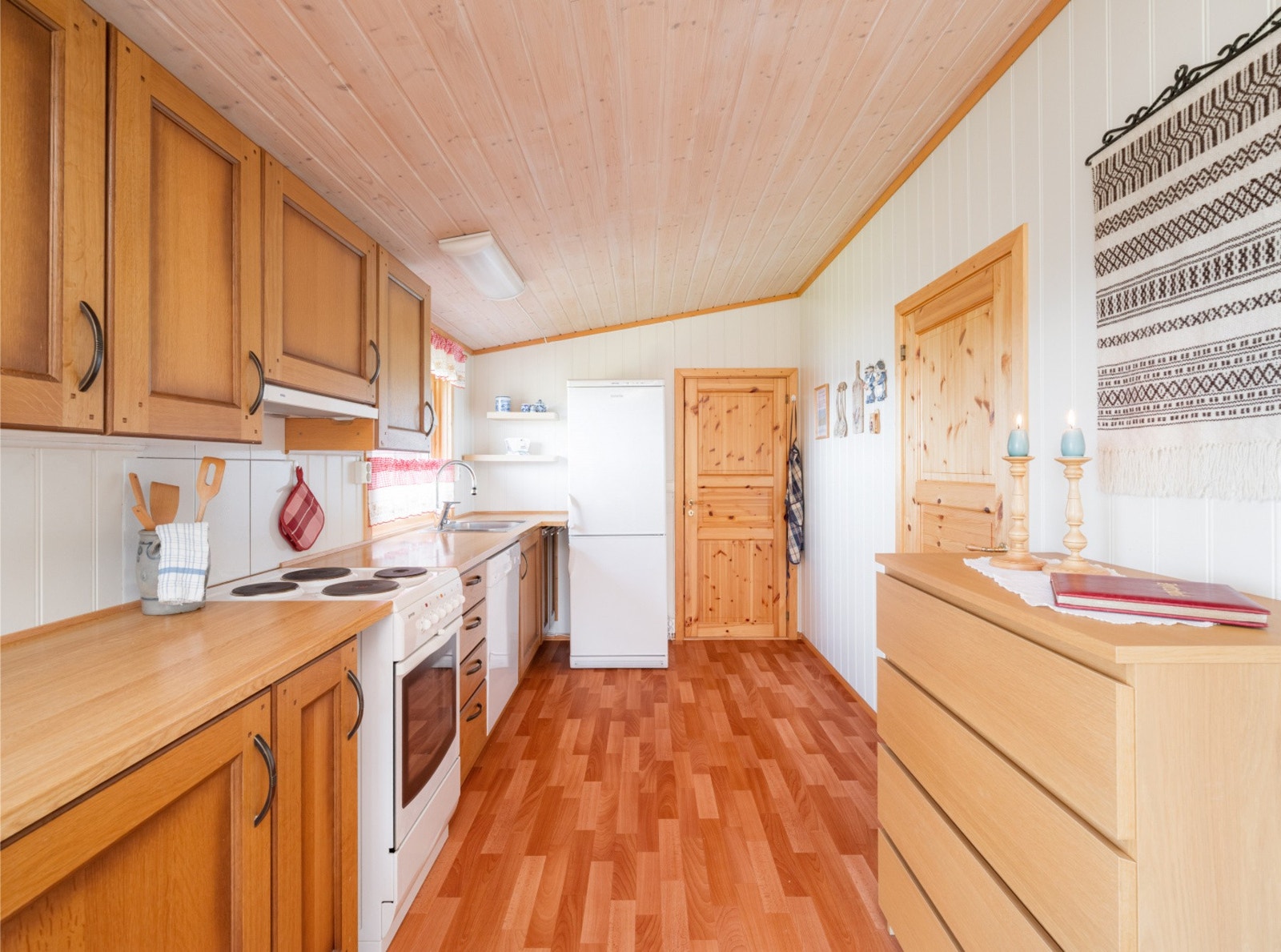 Klassisk kjøkken med folierte skrog og laminert benkeplate, som byr på godt med skap- og benkeplass. Galleribilde