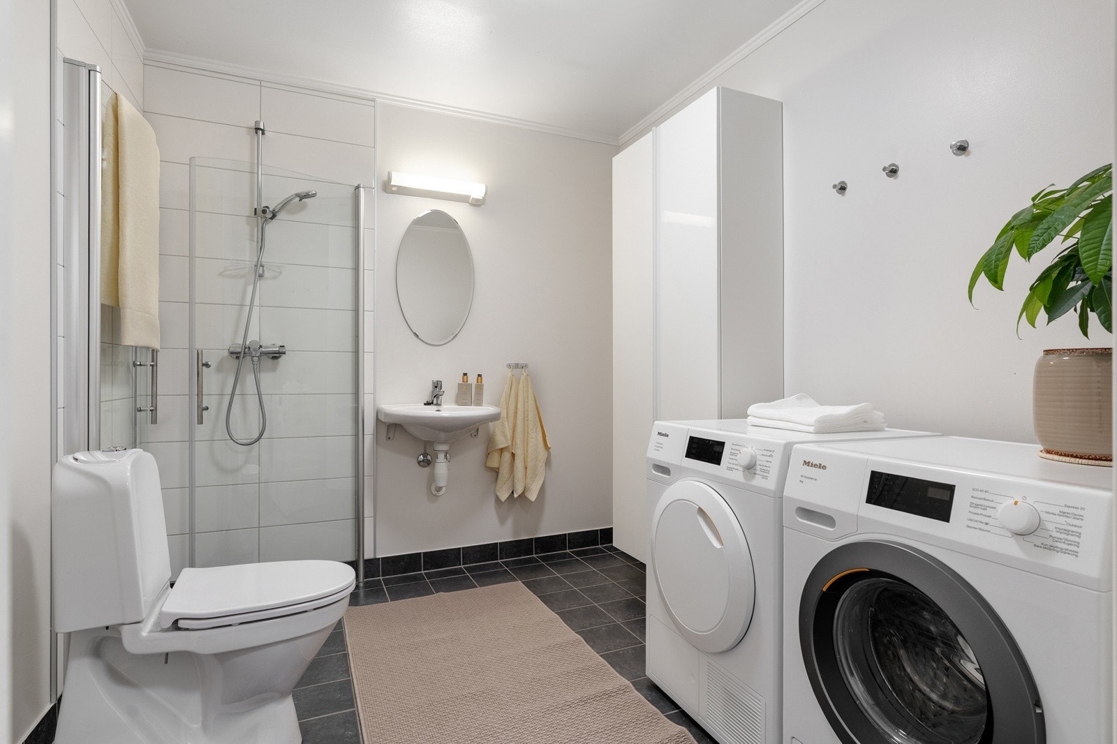 Badet i første etasje finner man like ved inngangen - enkelt og praktisk når de minste har kommet inn etter å ha lekt i regnværet og man ikke ønsker å dra søla inn i boligen. Galleribilde