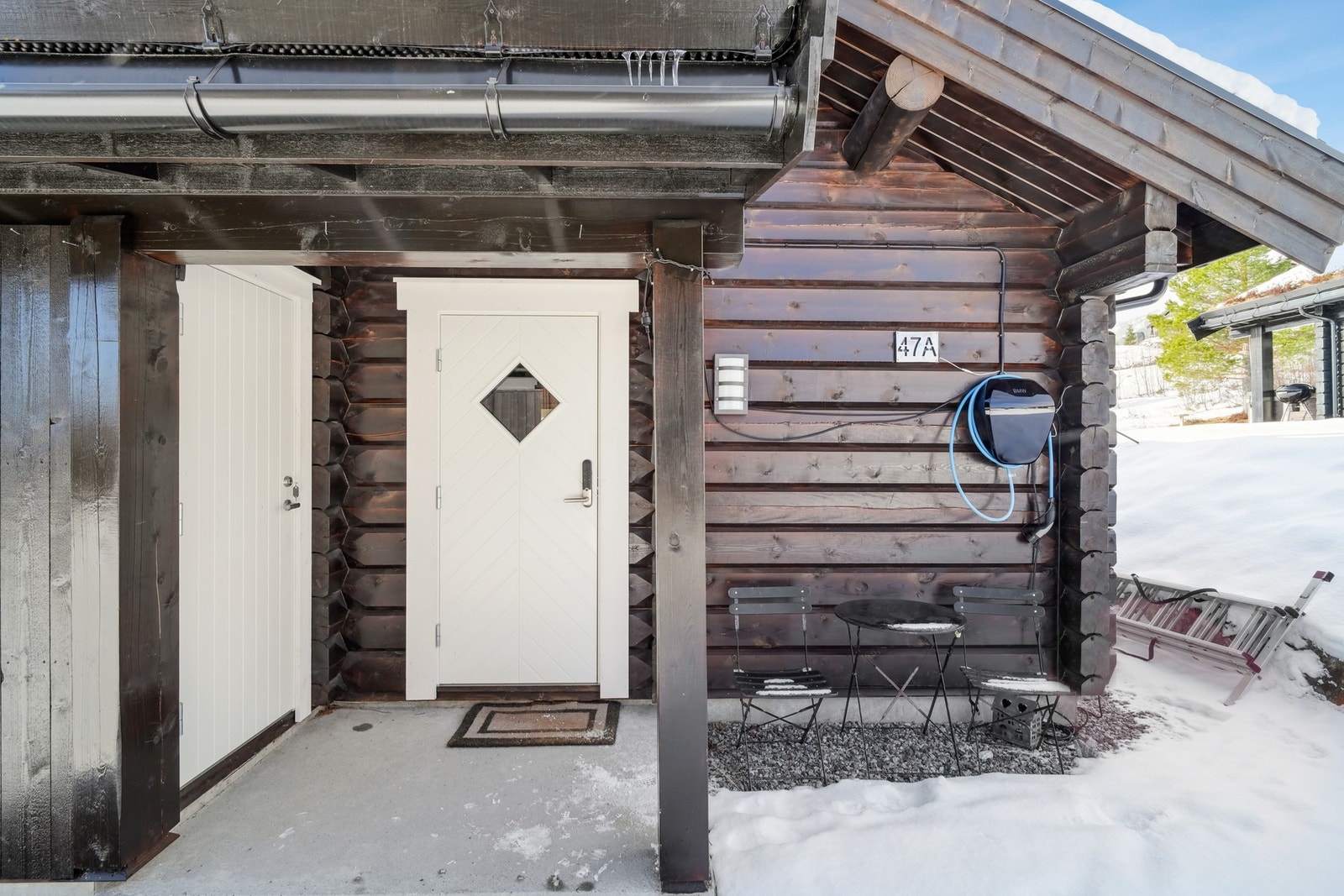 Overbygd entré og enkel tilkomst til utvendig bod på ca. 2 kvm. Det er installert elbil-lader fra BMW. Galleribilde