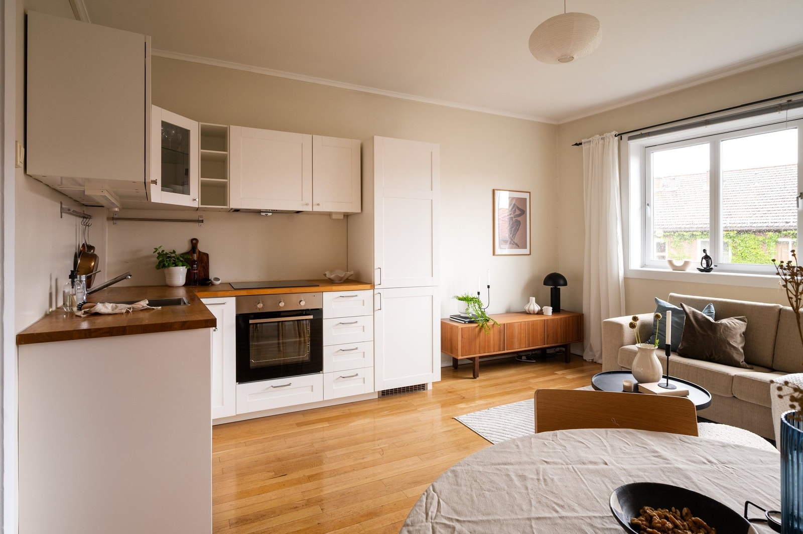 Kjøkkenet er innredet med lyse stilrene fronter, heltre benkeplate, ventilator og belysning under overskap. Godt med oppbevarings- og lagringsplass i skap, skuffer og på kjøkkenbenk. Platetopp, stekeovn og oppvaskmaskin er integrert i innredningen. Galleribilde