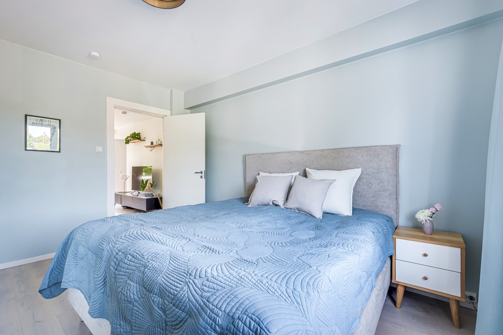 God plass til en stor dobbeltseng med tilhørende nattbord. Galleribilde