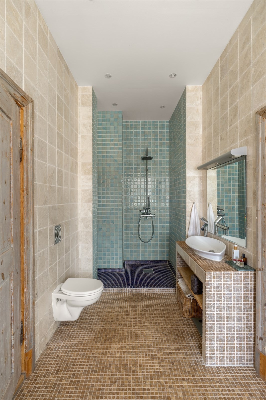 Badet i hovedetasjen er vakkert utformet med mosaikkfliser på gulv, marmorfliser på vegg og håndmalte italienske fliser i dusjhørnet. Galleribilde