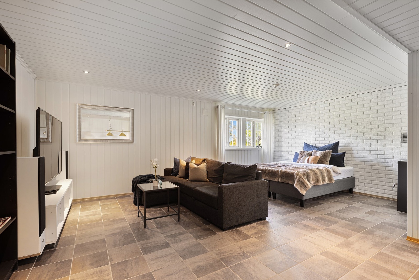 I underetasjen finner vi også en lun og innbydende kjellerstue som passer perfekt som ungdomsrom, ekstra stue eller multibruksrom for hele familien. Galleribilde