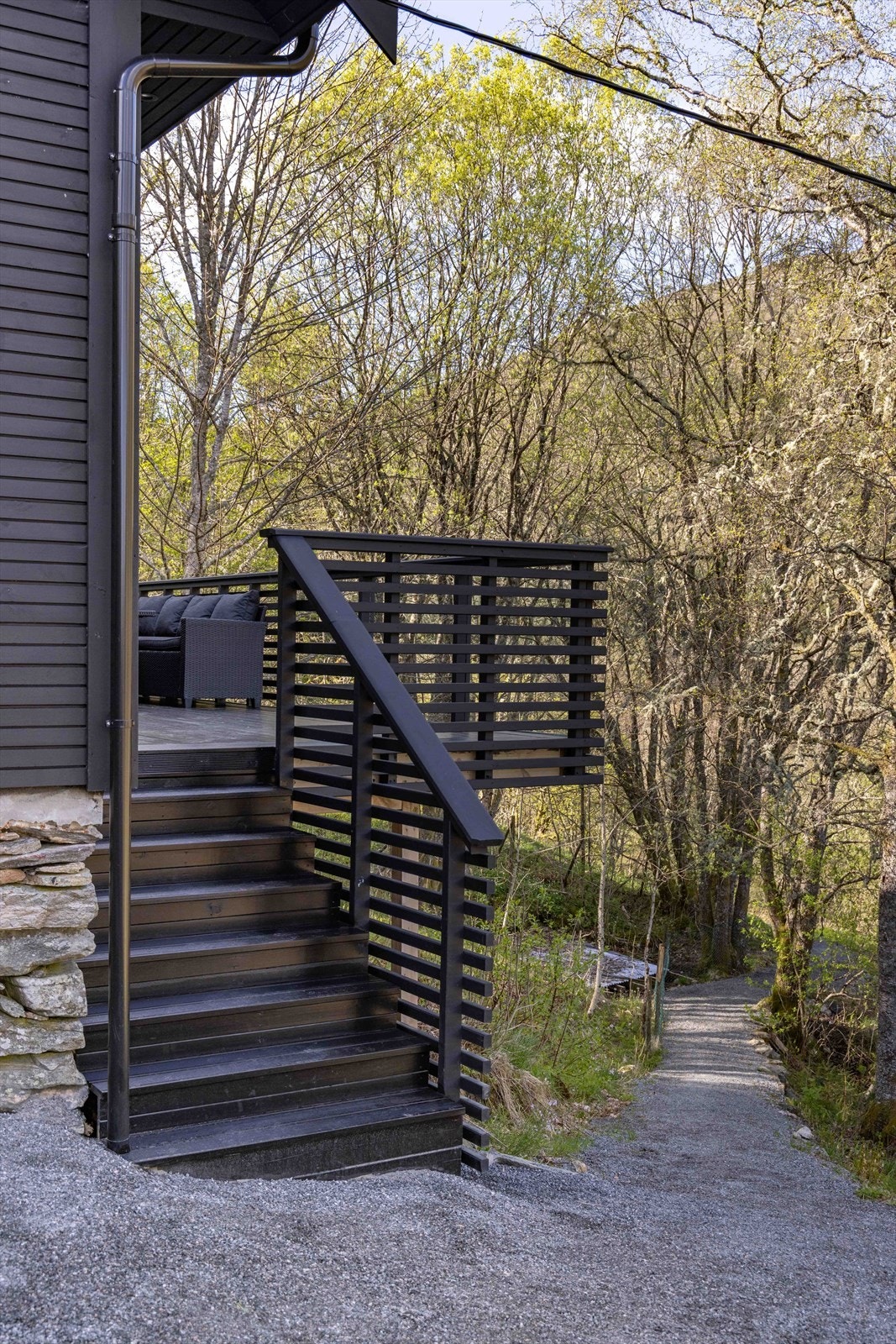 Det er trapp ned fra terrassen og til eiendommens hage. Galleribilde