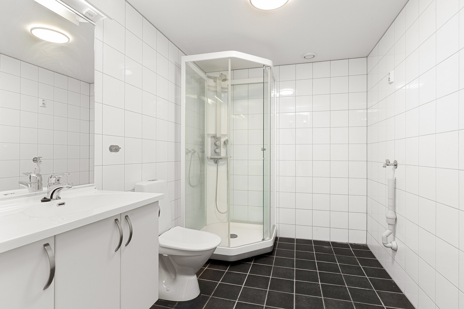 Badet er flislagt med dusjkabinett Galleribilde