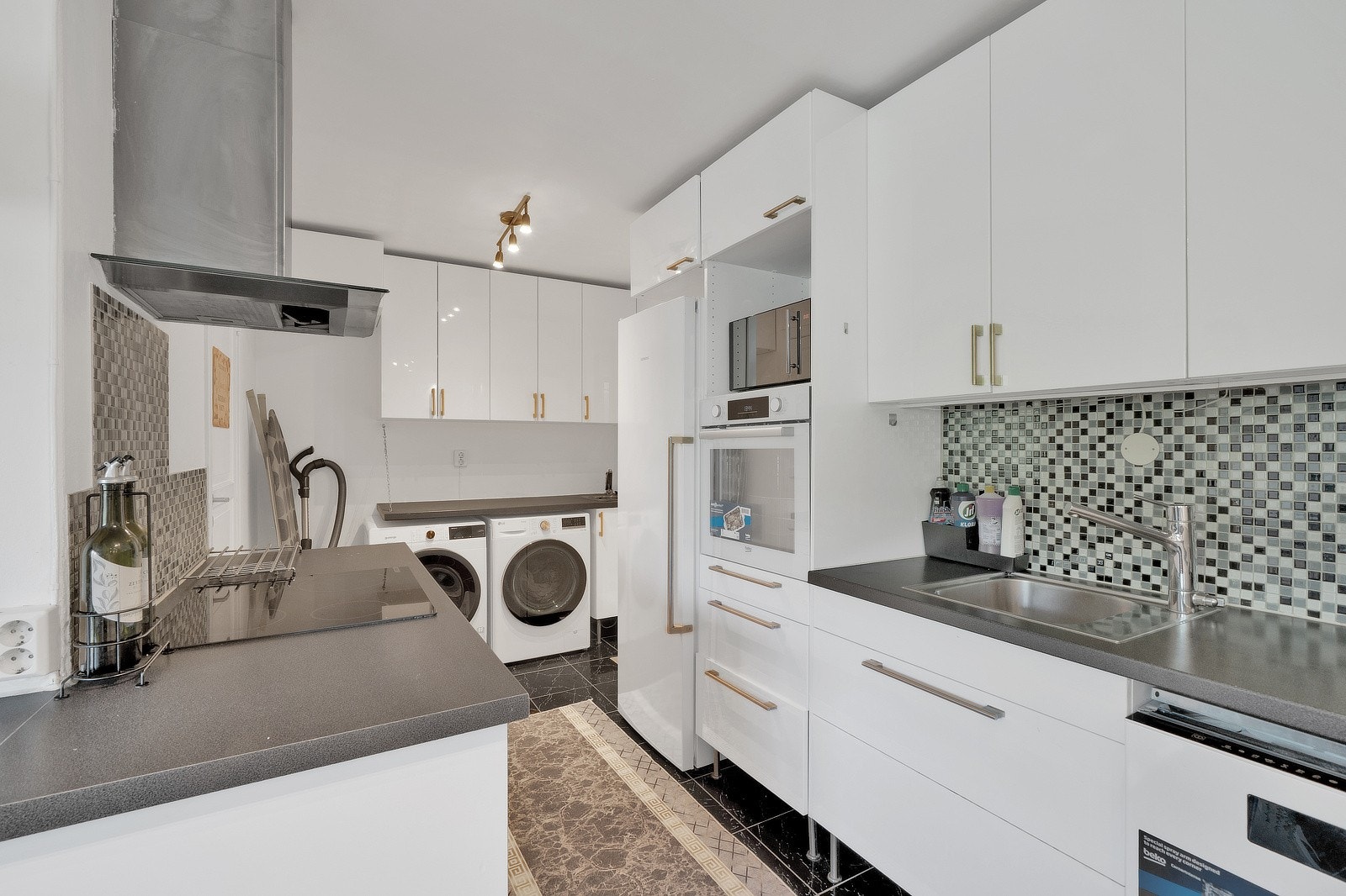 Det er montert integrert stekeovn og platetopp med ventilator, samt oppvaskmaskin. Kjøleskap er plassert i nisje som frittstående enhet. Galleribilde