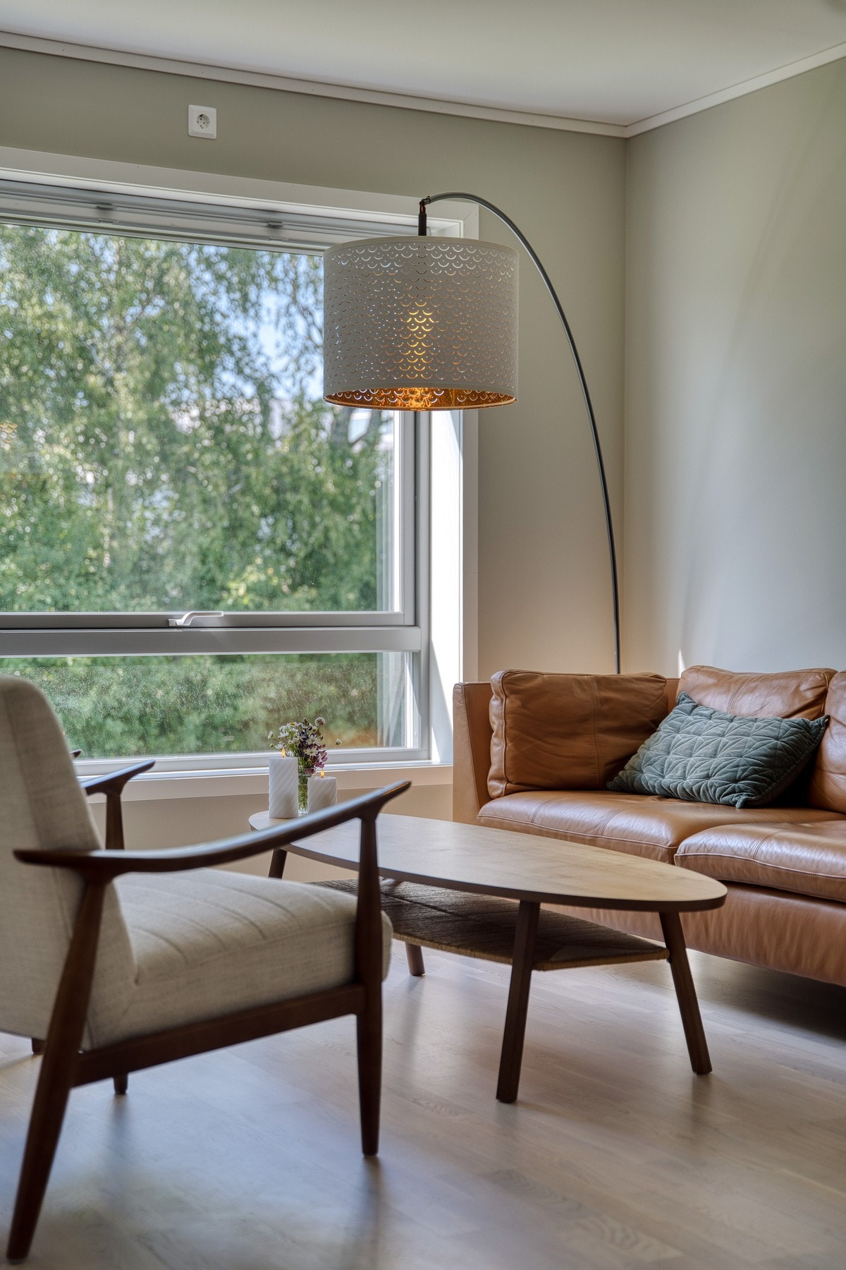 Den åpne forbindelsen mot spisestue og kjøkken gir en naturlig flyt i boligens sosiale soner Galleribilde