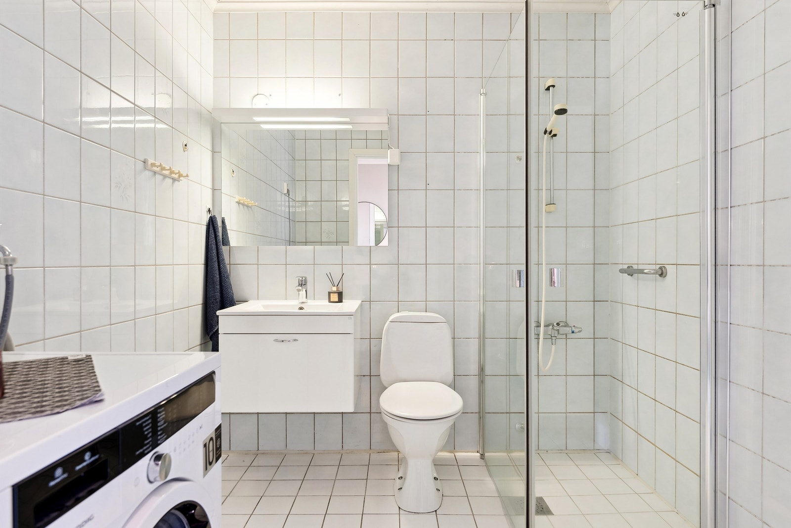 Tidløst bad med dusj, wc, baderomsinnredning og opplegg for vaskemaskin. Galleribilde