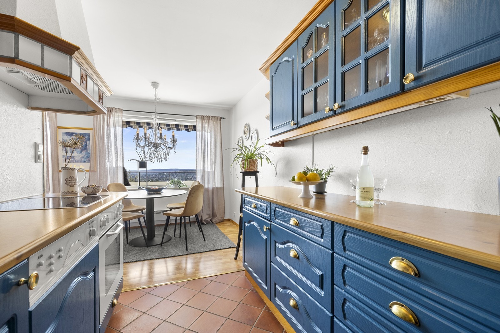 Separat kjøkken med fliser på gulv, samt mye skap- og benkeplass. Galleribilde