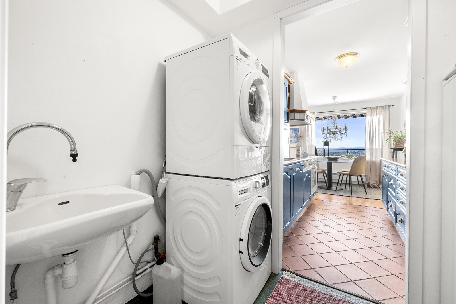 Boligen har et praktisk vaskerom innredet med vask og skap. Galleribilde