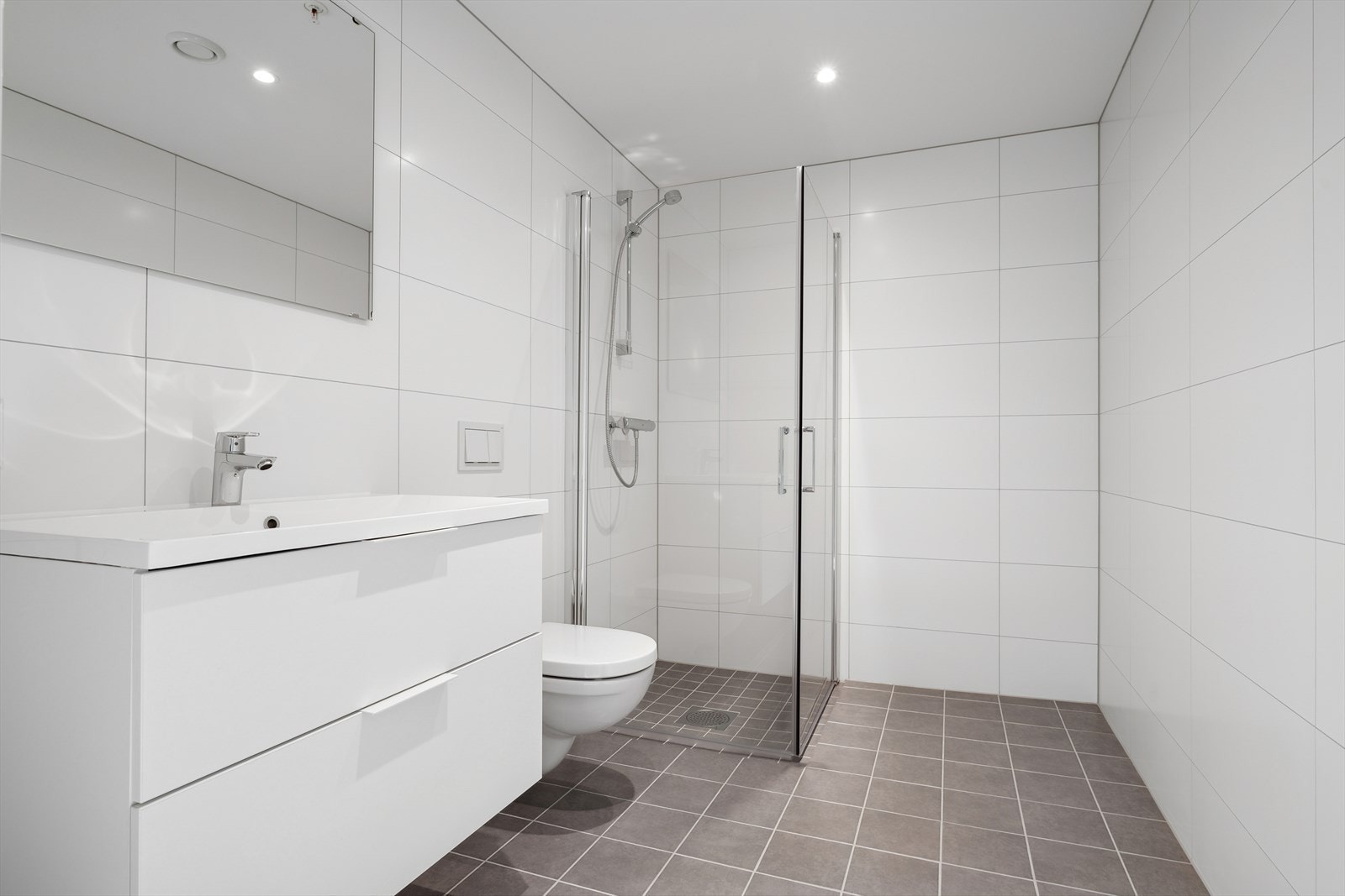 Bad/wc med dusjhjørne og nedfelt servant med skuffer under. Galleribilde