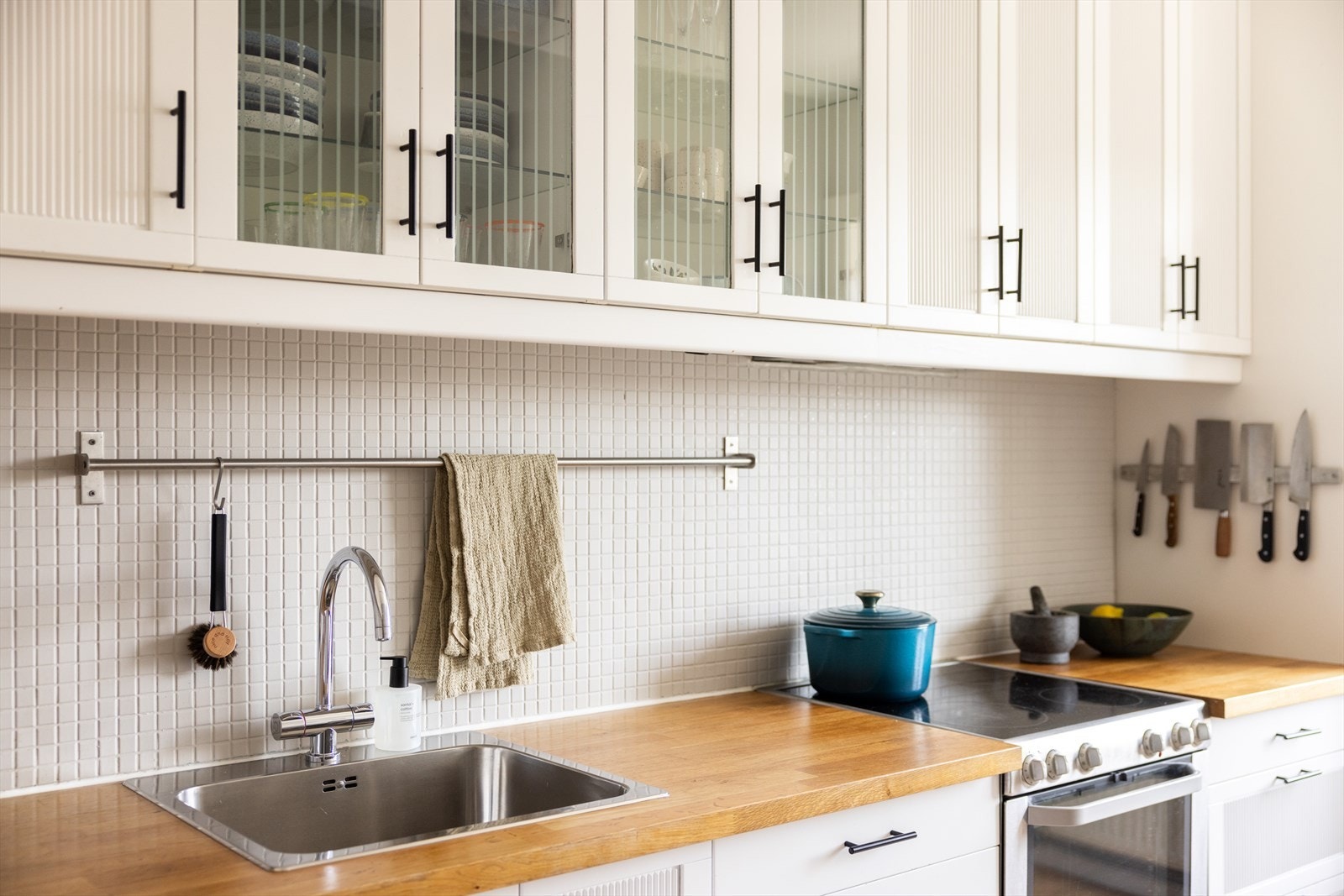 Kjøkkeninnredningen består av profilerte, hvite fronter og benkeplate av heltre med nedfelt vaskekum. Galleribilde