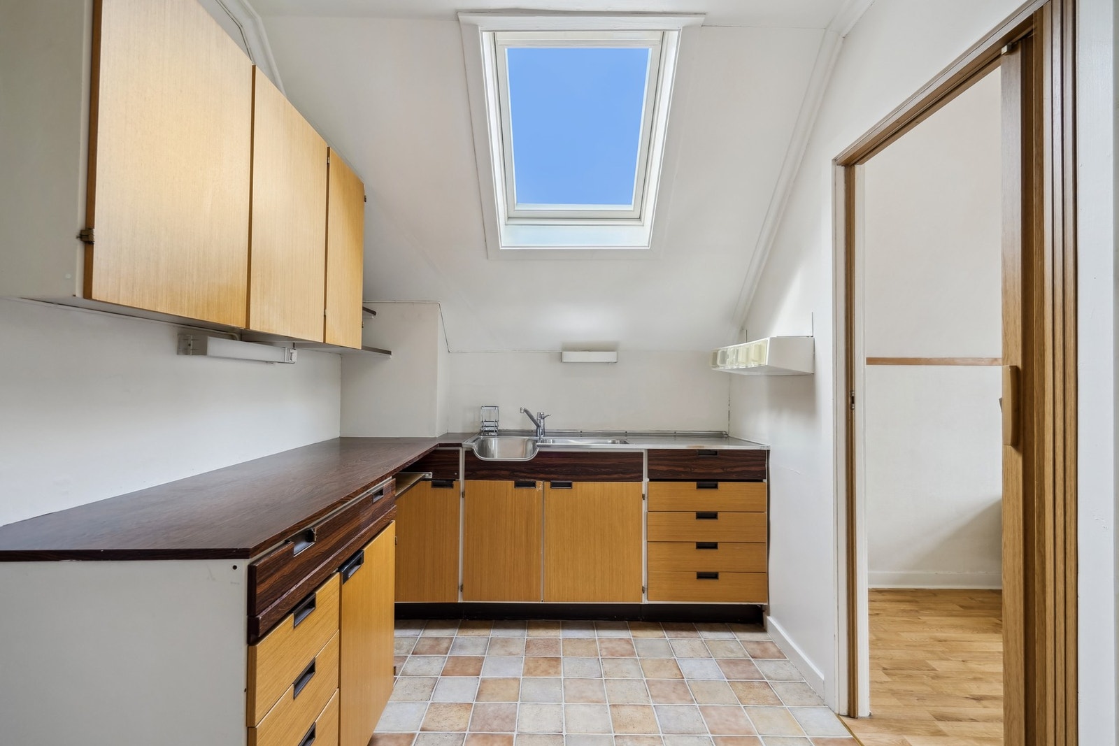 Kjøkkenet i 2. etasje har overskap og underskap, benkeplate av laminat og vask. Takvinduet gir god med lys inn. Galleribilde