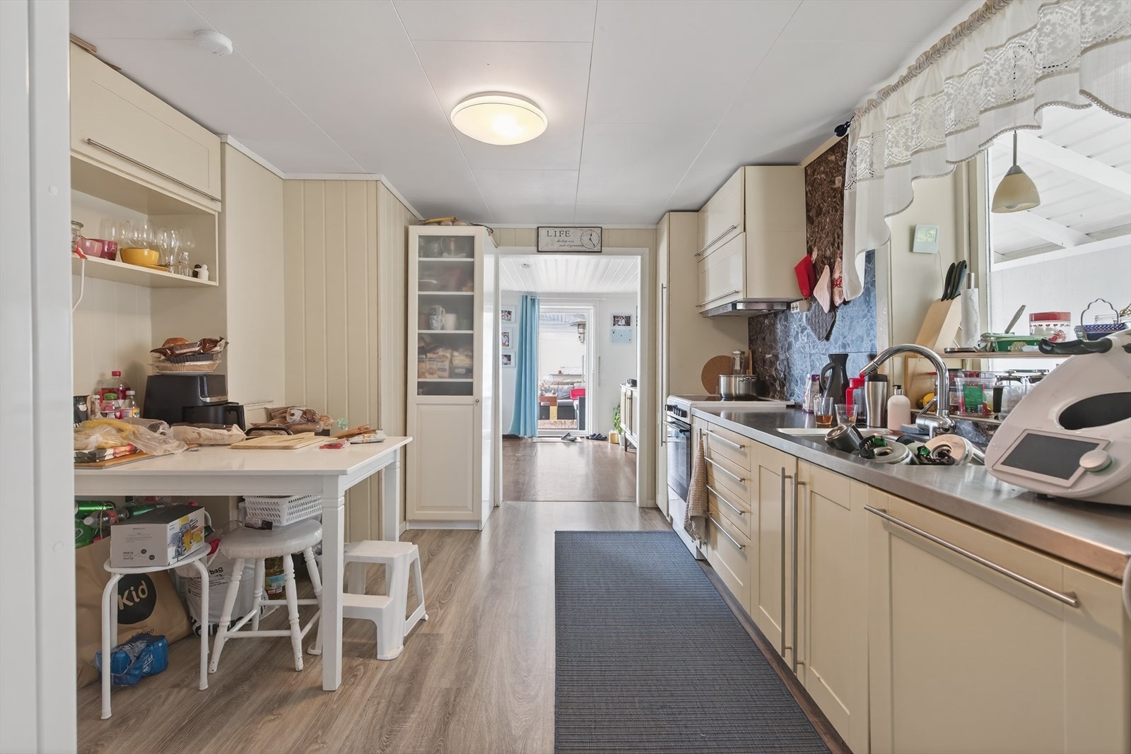 Romslig kjøkken med profilerte fronter. Integrert oppvaskmaskin, og plass til kjøkkenmøblement. Galleribilde