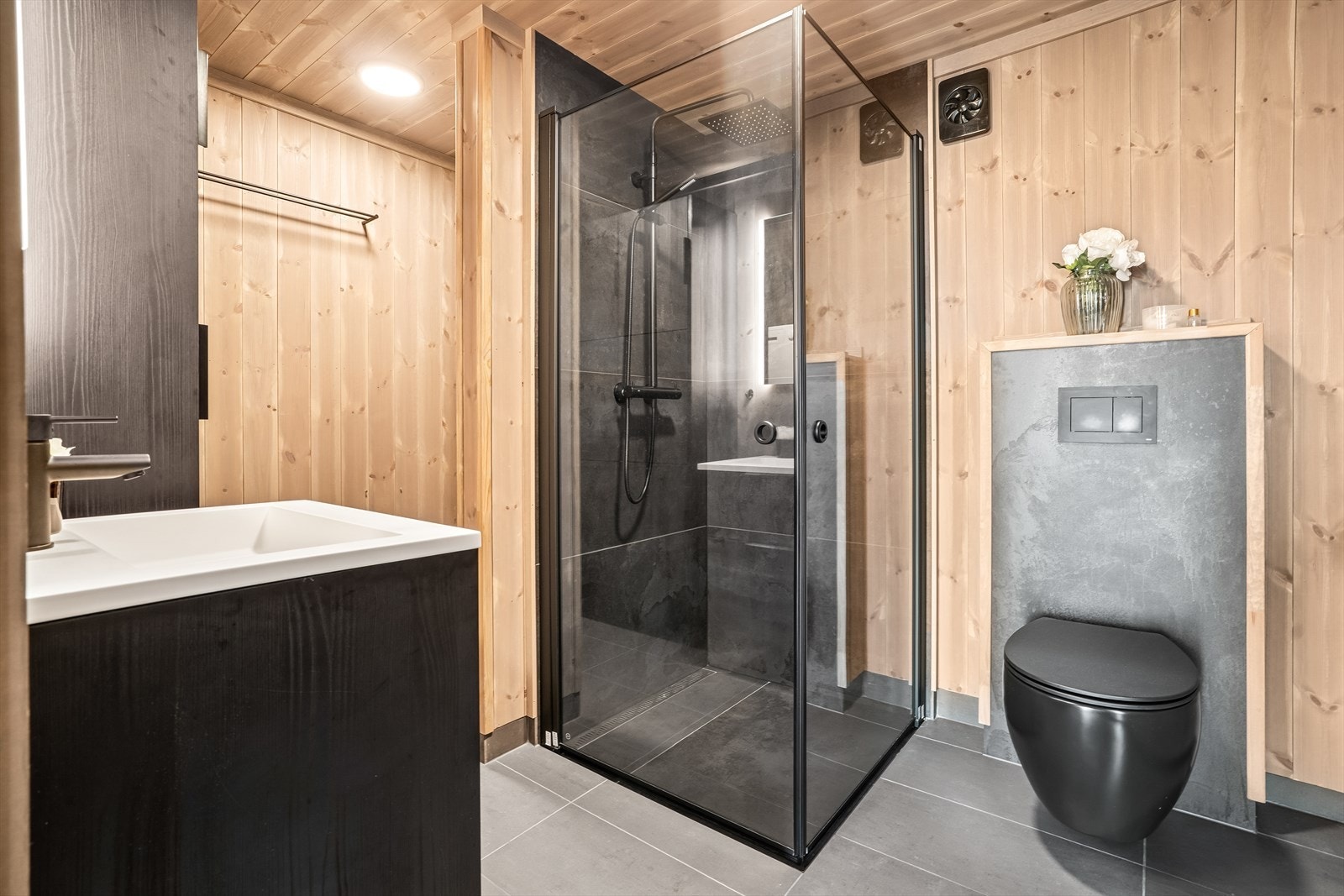 Bad/vaskerom i første etasje har innredning med nedfelt servant, veggmontert toalett, dusjvegger/hjørne og opplegg for vaskemaskin. Galleribilde