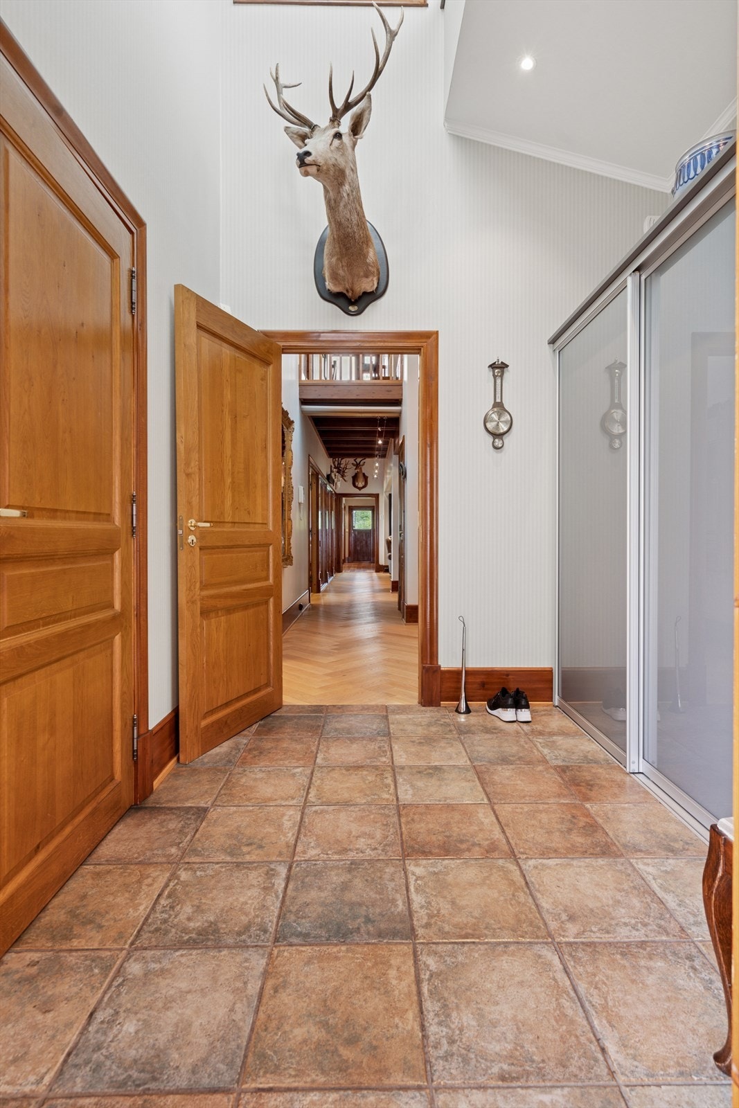 Du ønskes velkommen inn i en innbydende flislagt entrè som er utstyrt med skyvedørsgarderobe - Her har du også tilgang til en kjekk innvendig bod som gir deg ytterlige rom for oppbevaring av yttertøy og utstyr Galleribilde