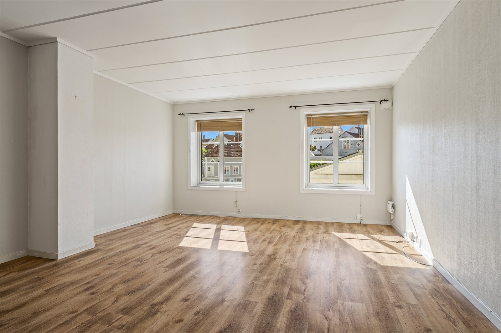Romslig stue med lysemalte overflater. Galleribilde