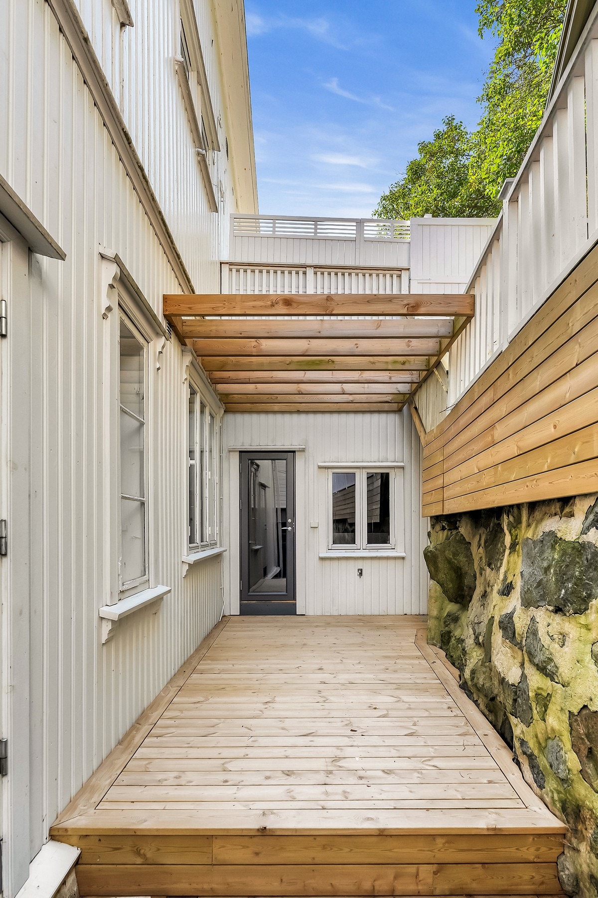 Terrassen er laget i tre og gir deg et praktisk uteområde som en del av boligen Galleribilde