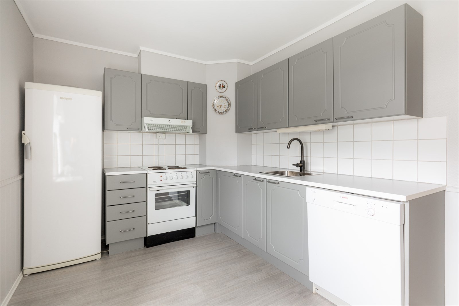 Kjøkkeninnredningen har profilerte fronter og laminat benkeplate, samt oppvaskkum i rustfritt stål. Galleribilde