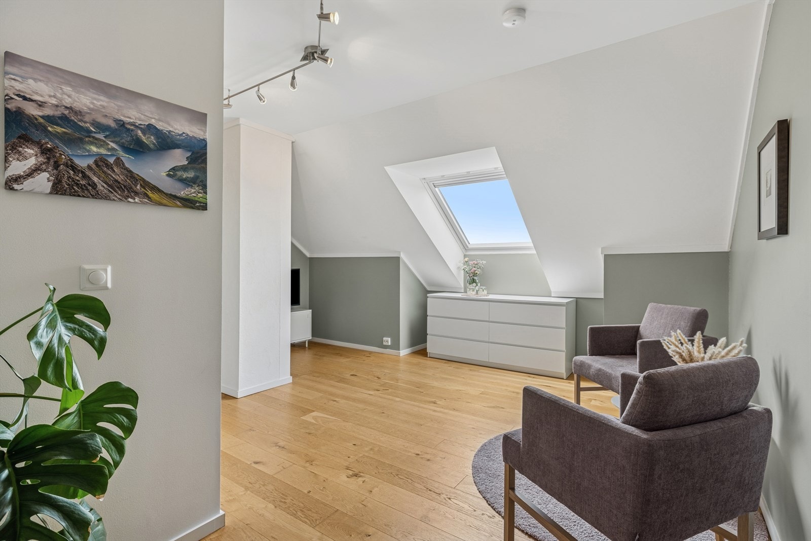 Loftstue til ungene med lyse overflater og velux vindu som slipper inn rikelig med lys Galleribilde