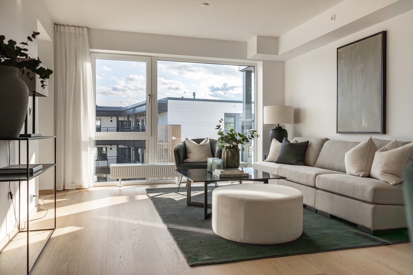 Lys og romslig stue med enorme vindusflater som bringer inn masse dagslys. Galleribilde