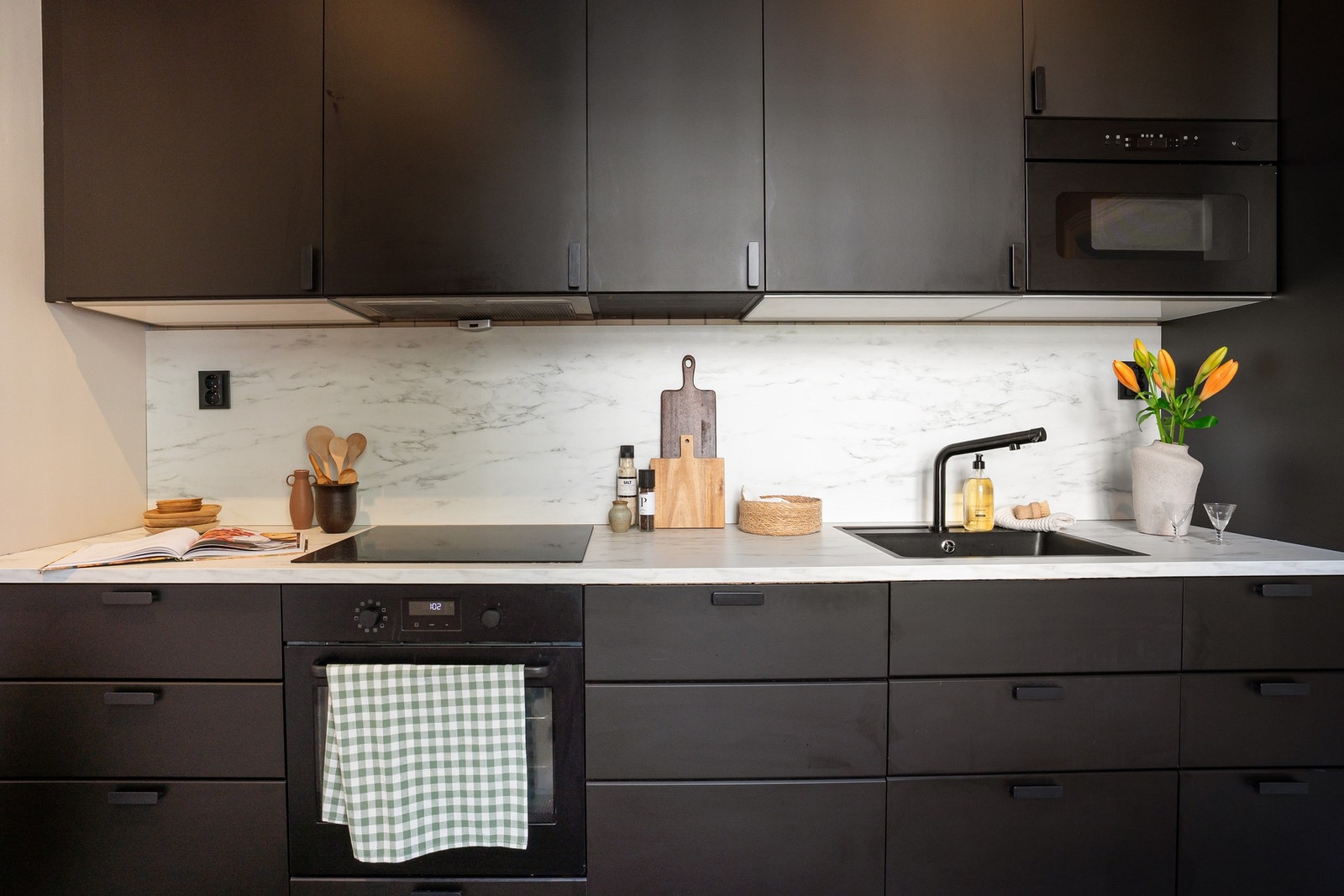 Moderne innredning med integrerte hvitevarer, slette fronter og laminat benkeplate. Galleribilde