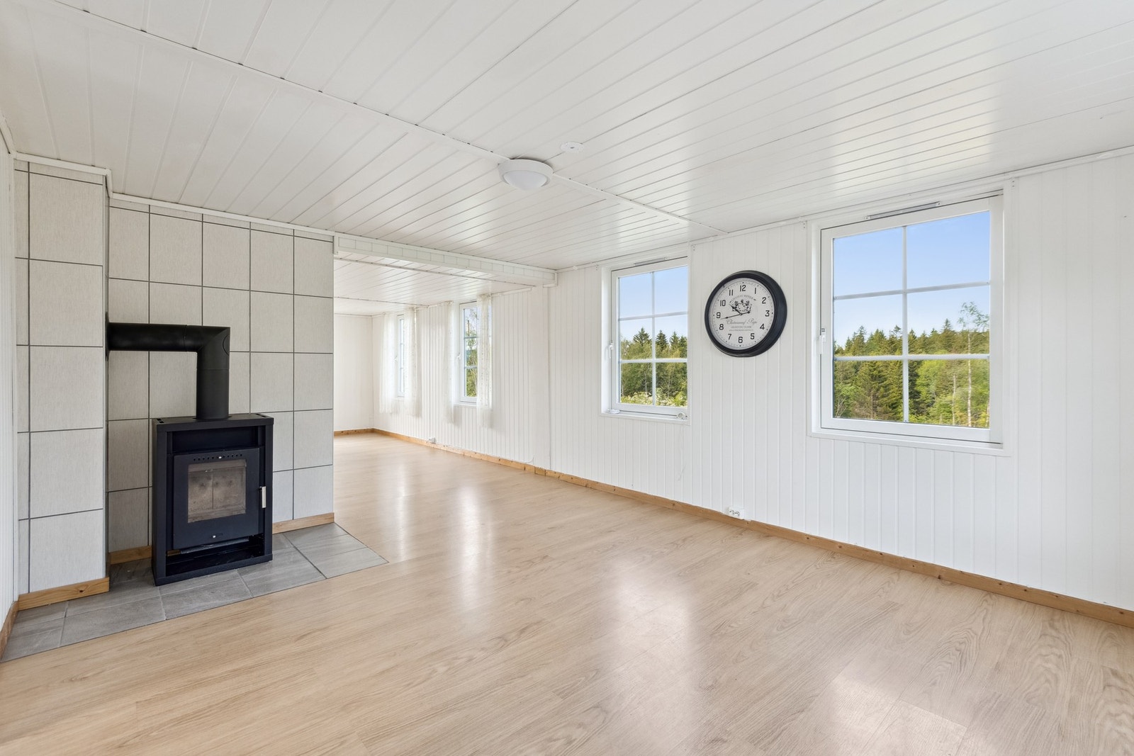 Romslig stue med gjennomlys fra tre sider. Galleribilde