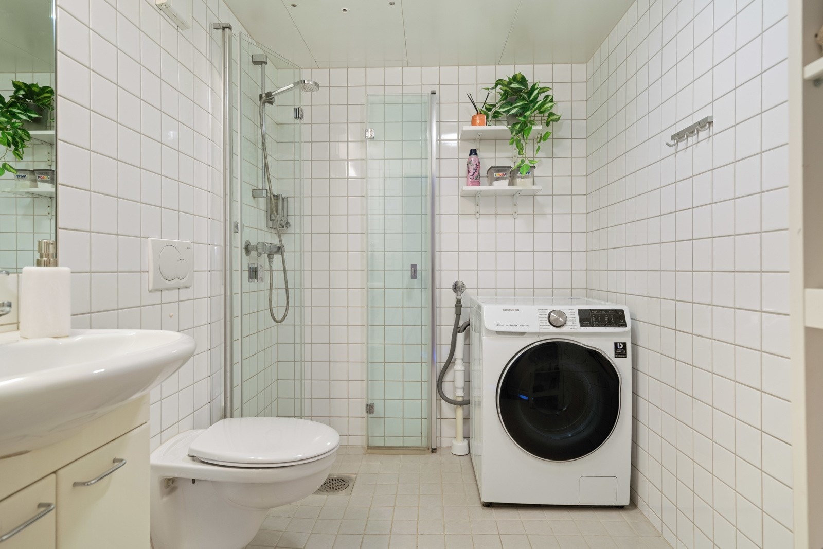 Flislagt bad fra byggeår med varmekabler i gulv. Boligen har kombinert vaskemaskin og tørk. Galleribilde