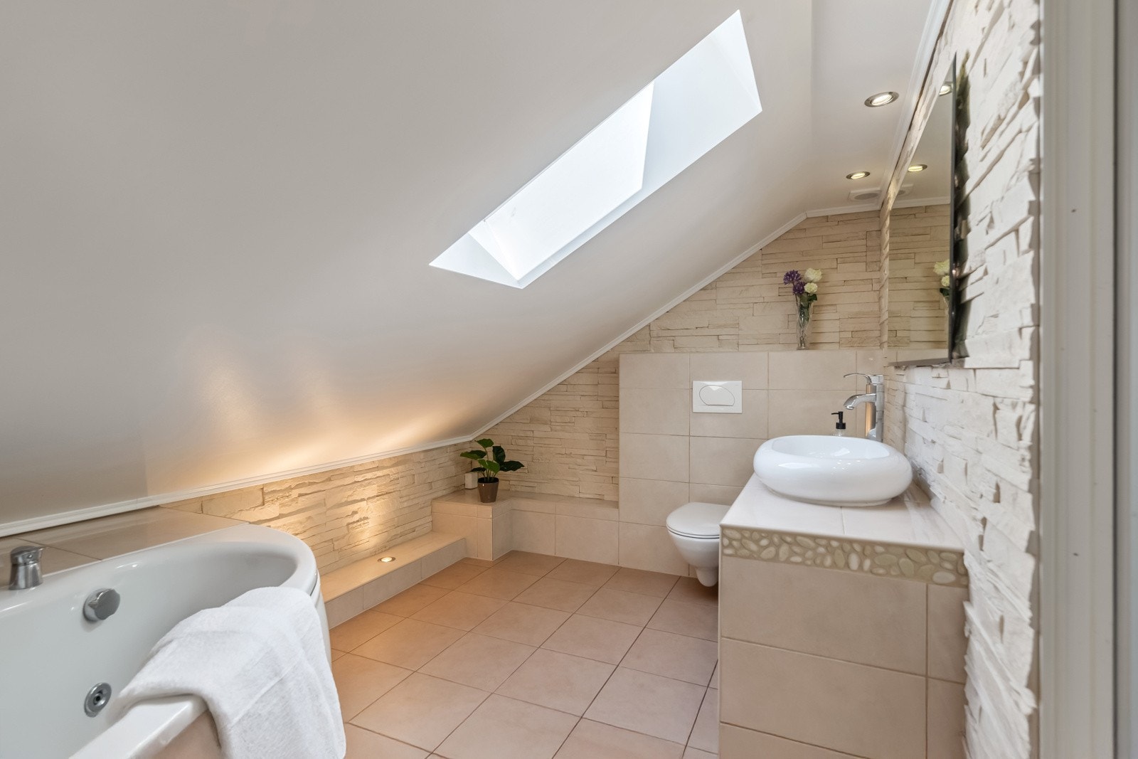 Badet er et delikat og flislagt baderom med badekar og spafølelse. Galleribilde