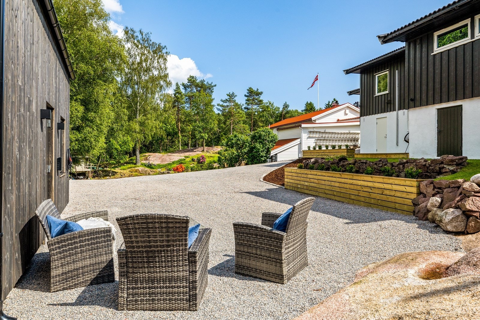 Her er det satt opp utemøbler som skaper en naturlig forlengelse av garasjen, og området har rikelig med sol store deler av dagen. Enten du nyter en kopp kaffe, tar en pause fra mekking eller samler familie og venner. Galleribilde