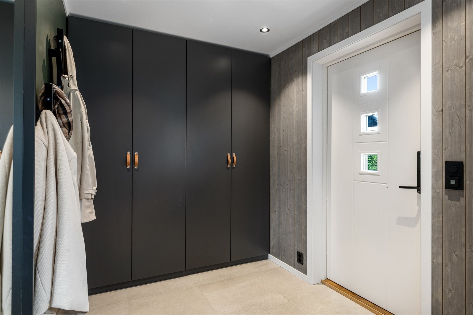 Inngangspartiet gir et svært godt førsteinntrykk - moderne, praktisk og innbydende. Gulvet er flislagt og har behagelige varmekabler som sørger for komfort året rundt, og downlights i himlingen gir god belysning og en stilren finish. Galleribilde